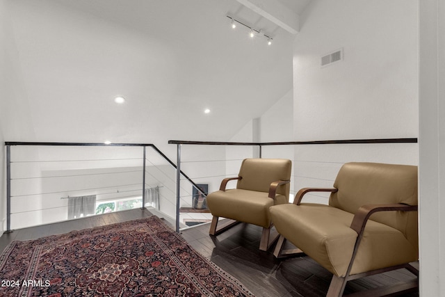 living area with rail lighting, wood-type flooring, and high vaulted ceiling