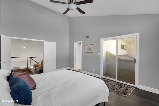 bedroom with a closet, dark hardwood / wood-style floors, high vaulted ceiling, and ceiling fan