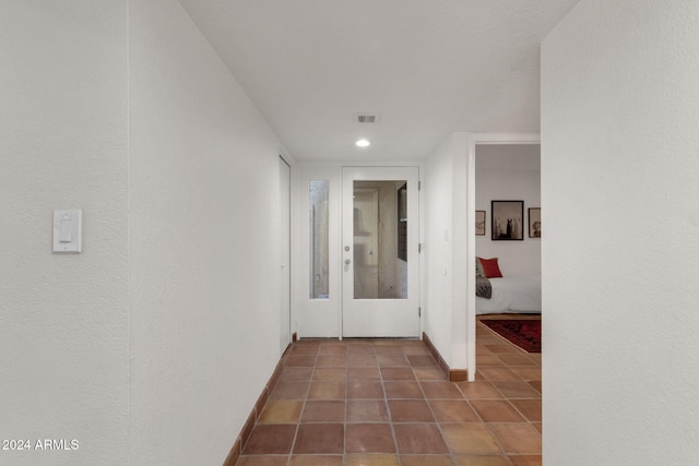 corridor with dark tile patterned flooring