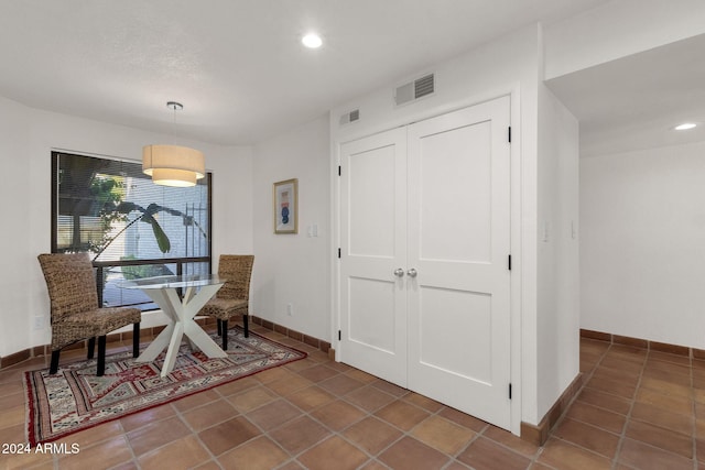 dining area with dark tile patterned flooring