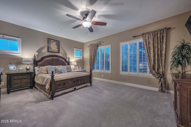 carpeted bedroom featuring ceiling fan and baseboards