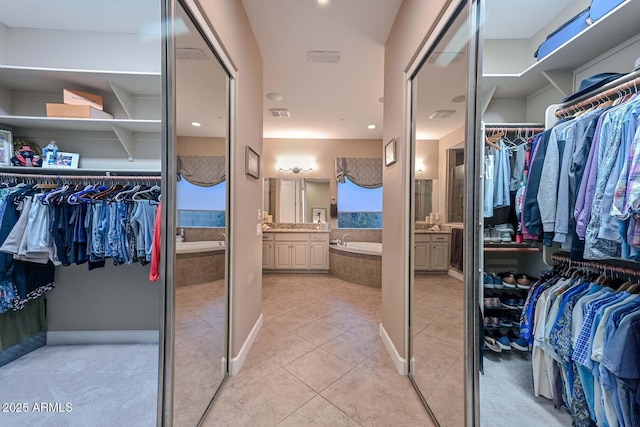 walk in closet with light tile patterned flooring