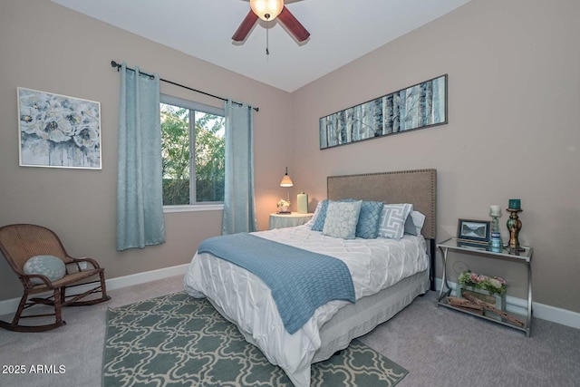 carpeted bedroom featuring baseboards and a ceiling fan