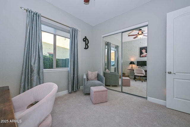 sitting room featuring carpet floors, ceiling fan, and baseboards