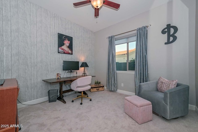 carpeted home office with baseboards and a ceiling fan