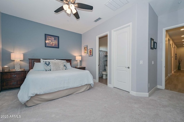 bedroom with carpet, visible vents, ensuite bath, and baseboards