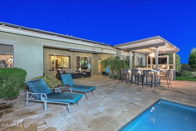 view of patio / terrace featuring an outdoor hangout area, an outdoor pool, outdoor dry bar, and a pergola