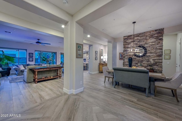 living area featuring baseboards, a ceiling fan, wood finished floors, a wood stove, and recessed lighting