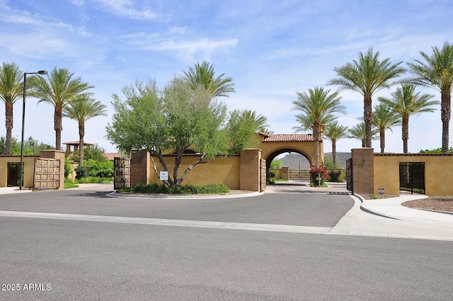 view of front facade with a gate and stucco siding