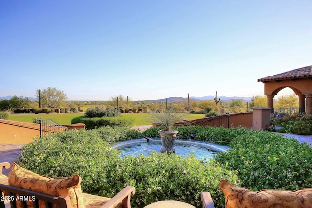 view of yard featuring fence and a mountain view