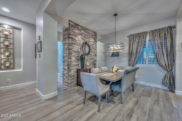 dining area featuring baseboards and wood finished floors