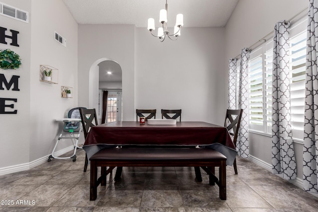 5354 E Ellis St, Mesa, AZ 85205 - dining area with arched walkways, a chandelier, and healthy amount of natural light
