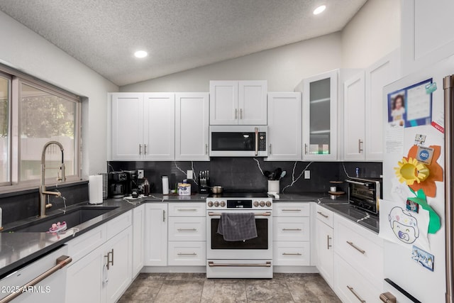 5354 E Ellis St, Mesa, AZ 85205 - kitchen featuring white appliances, lofted ceiling, decorative backsplash, white cabinetry, and a textured ceiling