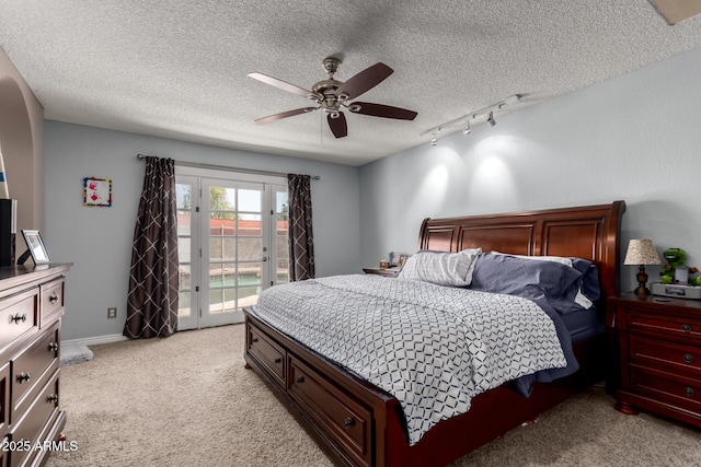 5354 E Ellis St, Mesa, AZ 85205 - bedroom with access to outside, a textured ceiling, light colored carpet, rail lighting, and a ceiling fan