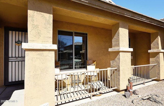 view of exterior entry featuring stucco siding