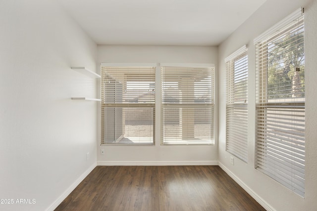 empty room featuring dark hardwood / wood-style flooring