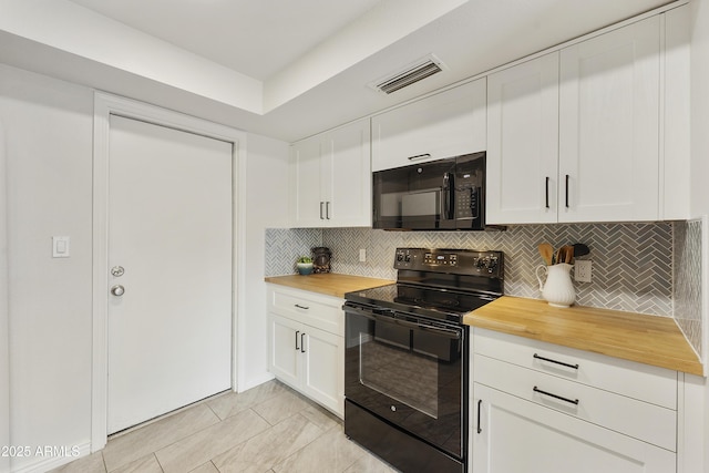 kitchen with wooden counters, black appliances, white cabinets, decorative backsplash, and light tile patterned floors