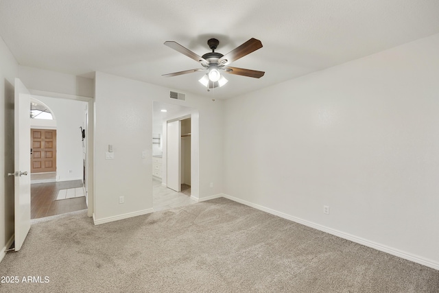 spare room with light carpet and ceiling fan