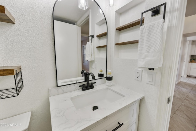 bathroom with built in features, vanity, and toilet