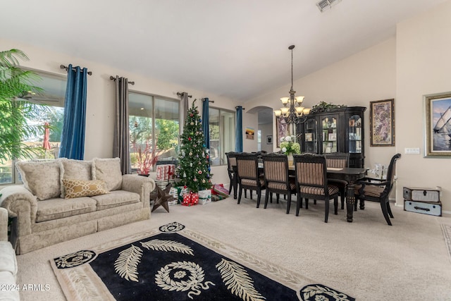 living room featuring carpet, an inviting chandelier, vaulted ceiling, and a healthy amount of sunlight