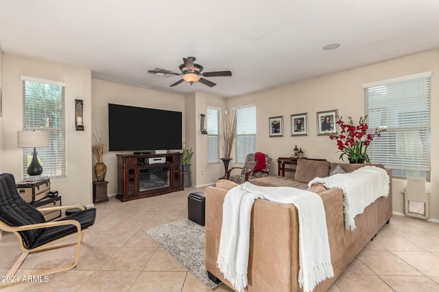 tiled living room featuring plenty of natural light and ceiling fan