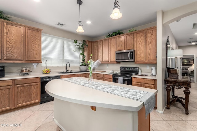 kitchen with sink, a center island, hanging light fixtures, light tile patterned flooring, and black appliances