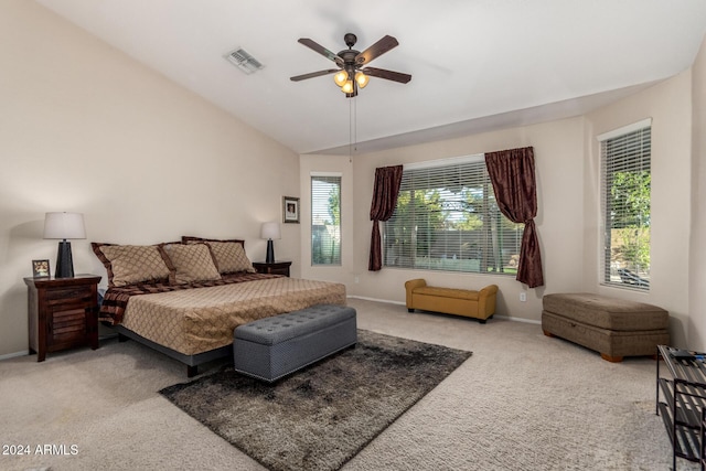 carpeted bedroom with ceiling fan and lofted ceiling