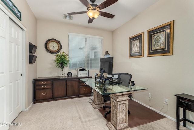 carpeted office space with ceiling fan