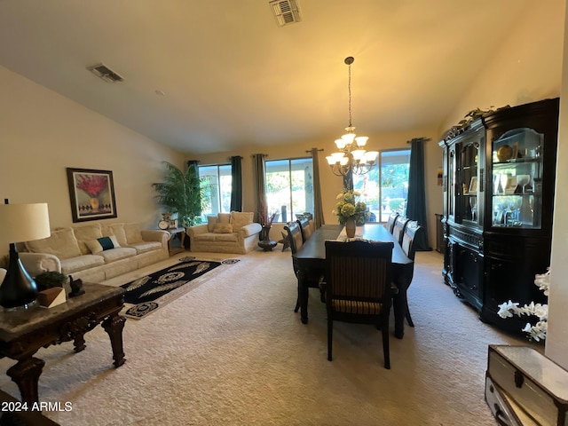 dining area featuring carpet flooring, a chandelier, and lofted ceiling