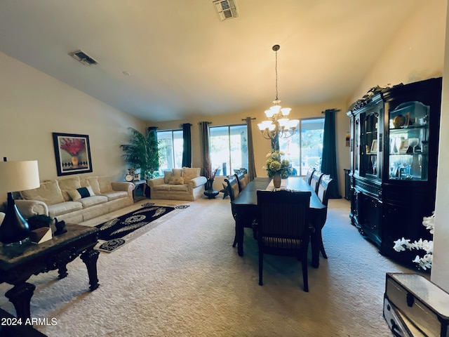 dining area featuring carpet flooring, lofted ceiling, and an inviting chandelier