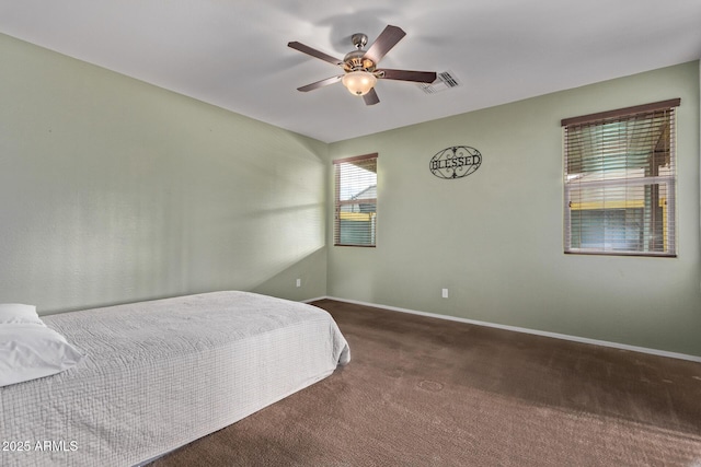 bedroom with dark colored carpet and ceiling fan