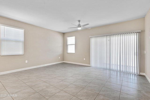 unfurnished room with ceiling fan and baseboards