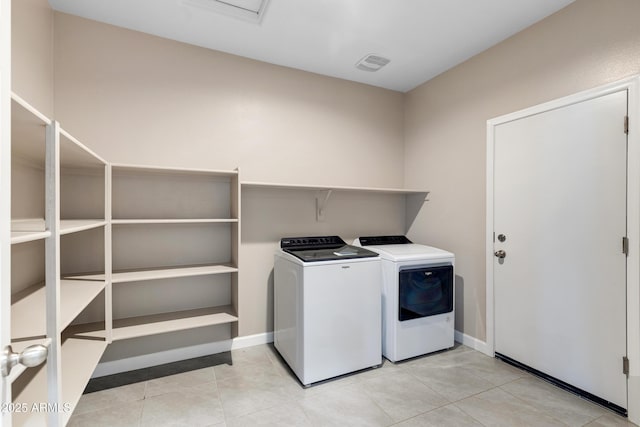 laundry area with laundry area, visible vents, independent washer and dryer, and light tile patterned floors