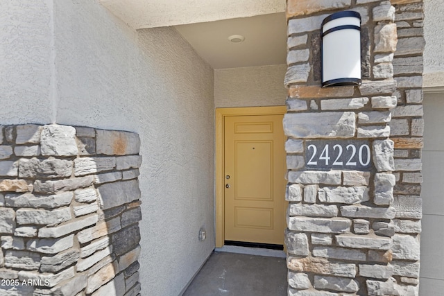 view of exterior entry with stucco siding