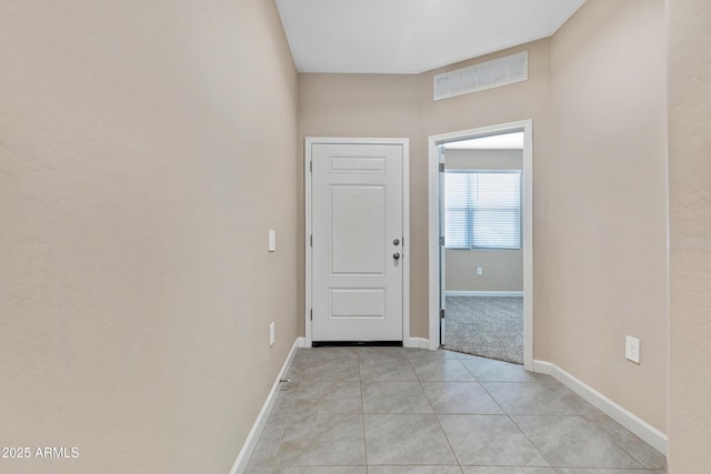 entryway with light tile patterned floors, visible vents, and baseboards