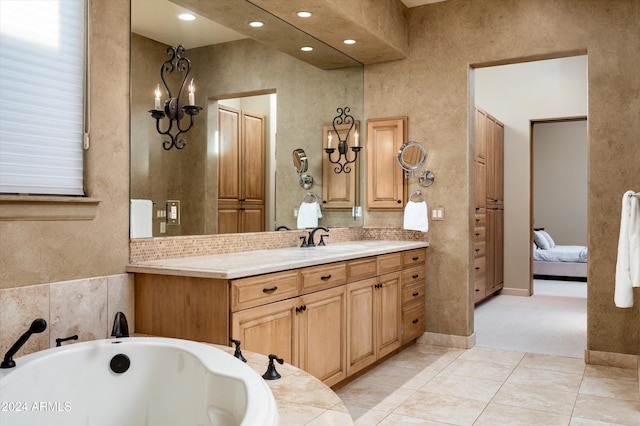 bathroom featuring a tub to relax in, tile patterned flooring, and vanity