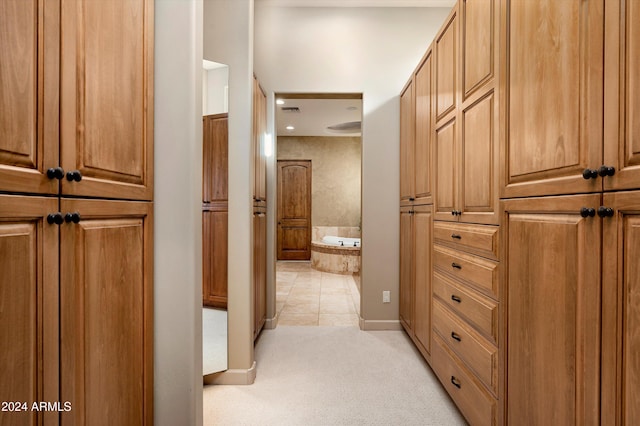 hall featuring light tile patterned floors