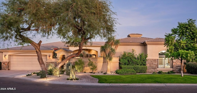 mediterranean / spanish house with a garage