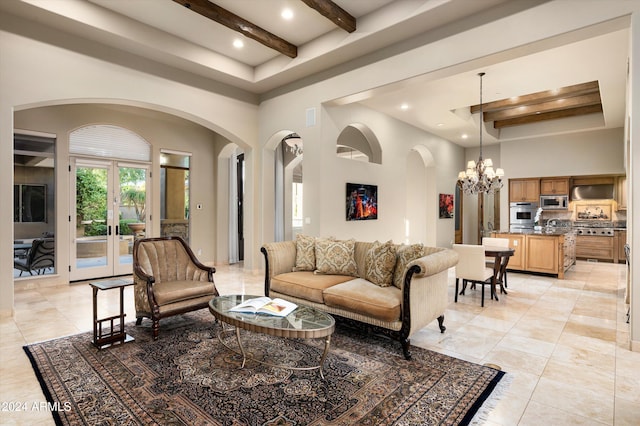 tiled living room featuring beam ceiling, french doors, a towering ceiling, and an inviting chandelier