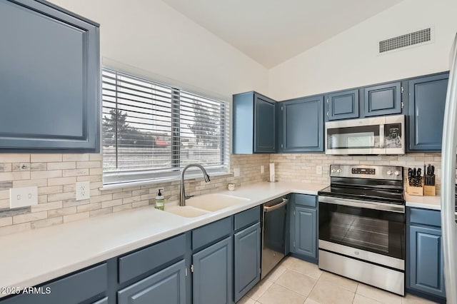 kitchen with light tile patterned floors, a sink, visible vents, appliances with stainless steel finishes, and decorative backsplash