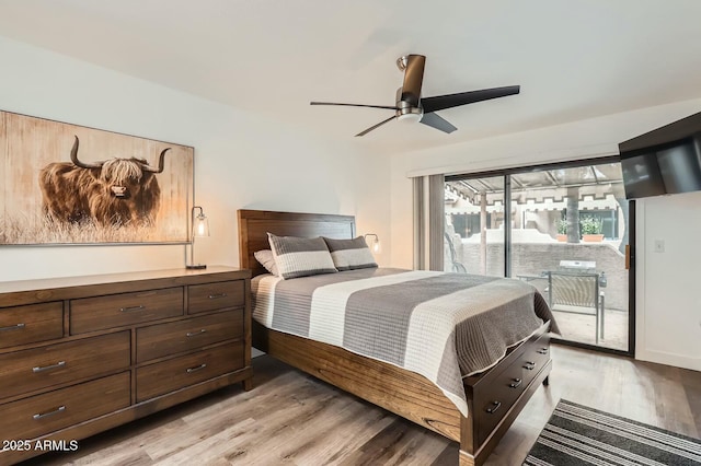 bedroom with access to exterior, light wood-style flooring, and ceiling fan