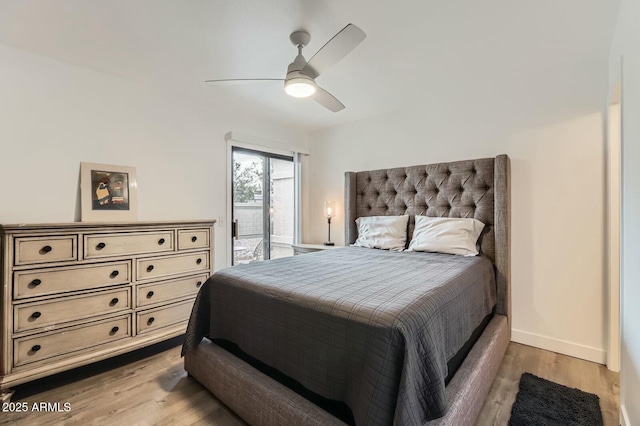 bedroom featuring a ceiling fan, access to outside, baseboards, and wood finished floors