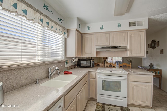 kitchen featuring sink, light tile patterned floors, white range with electric stovetop, light brown cabinetry, and kitchen peninsula