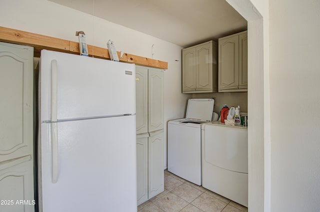 clothes washing area featuring light tile patterned floors and washer and clothes dryer