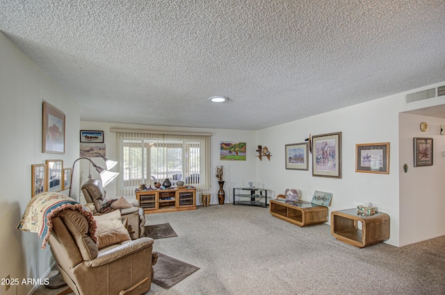 carpeted living room featuring a textured ceiling