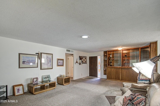 carpeted living room with a textured ceiling