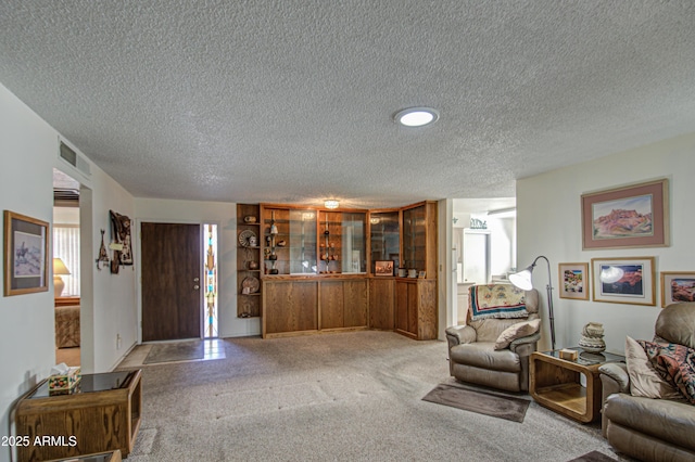 living room featuring a textured ceiling and carpet