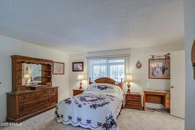 bedroom with light colored carpet and a textured ceiling