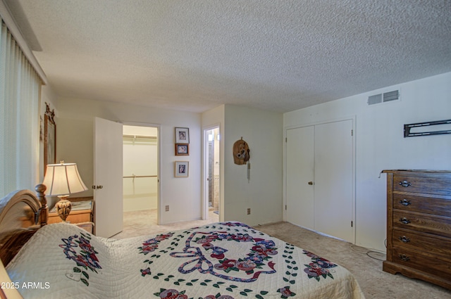 carpeted bedroom featuring a textured ceiling