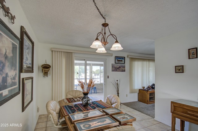 tiled dining space with a textured ceiling